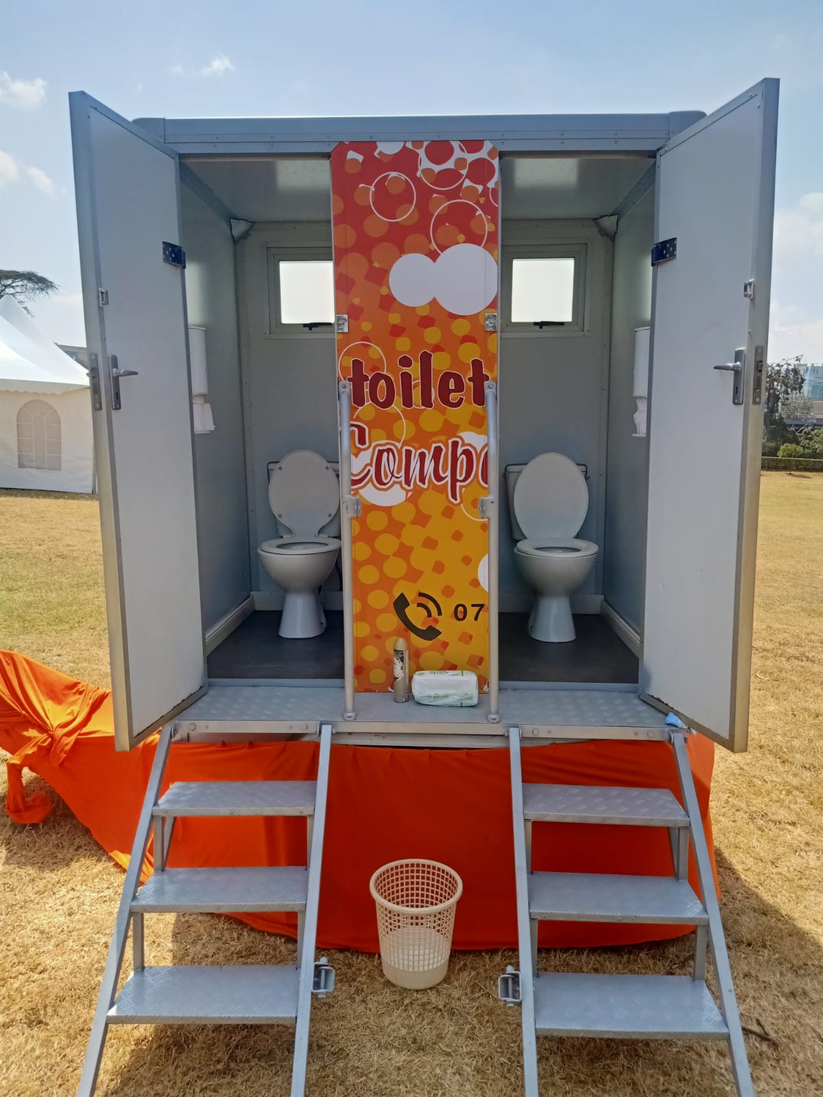 Attendant preparing a mobile restroom unit before an event